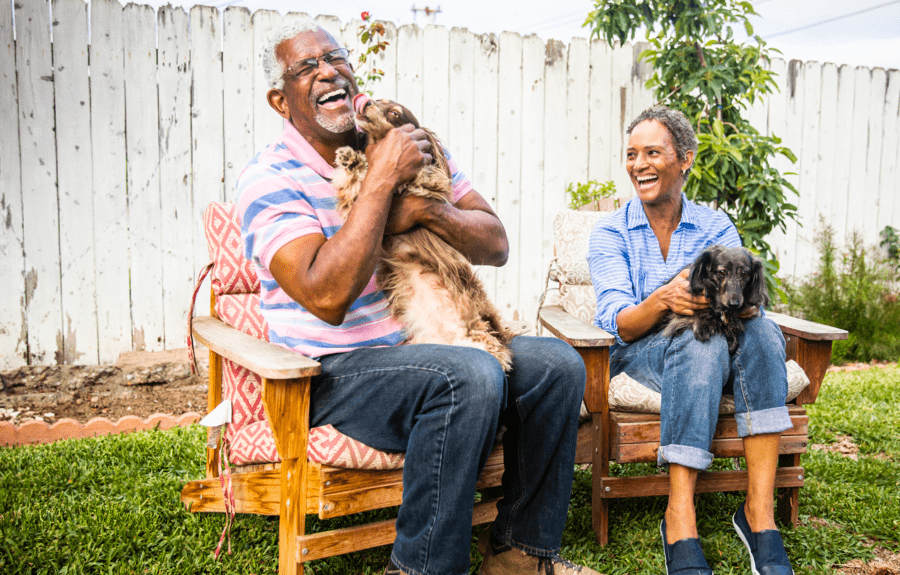 Woman and man holding pets and laughing | BCBS of Tennessee
